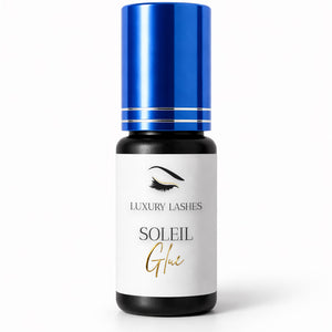 Soleil Glue eyelash extension adhesive with blue cap in a studio setting