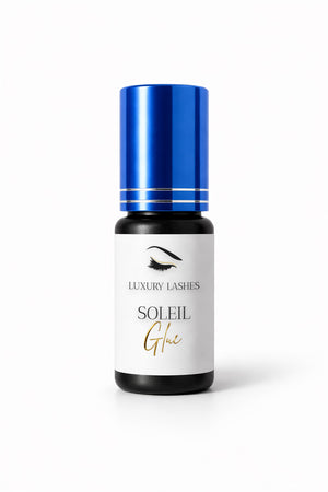 Soleil Glue eyelash extension adhesive with blue cap in a studio setting